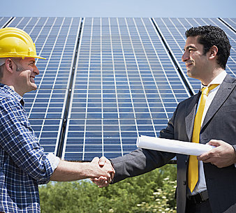 electrician and businessman shaking hands